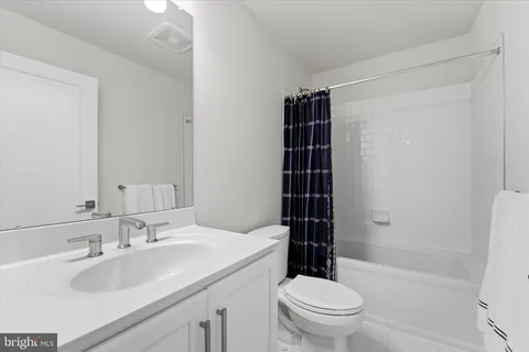 a bathroom with a sink toilet vanity and shower