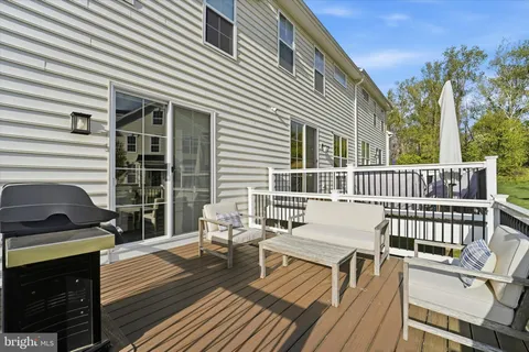 a view of a roof deck with wooden floor and fence