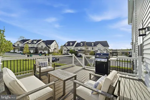 a view of a chairs and table on the roof deck