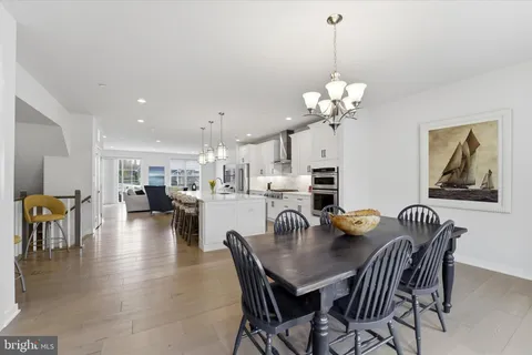 a dining room with furniture and chandelier