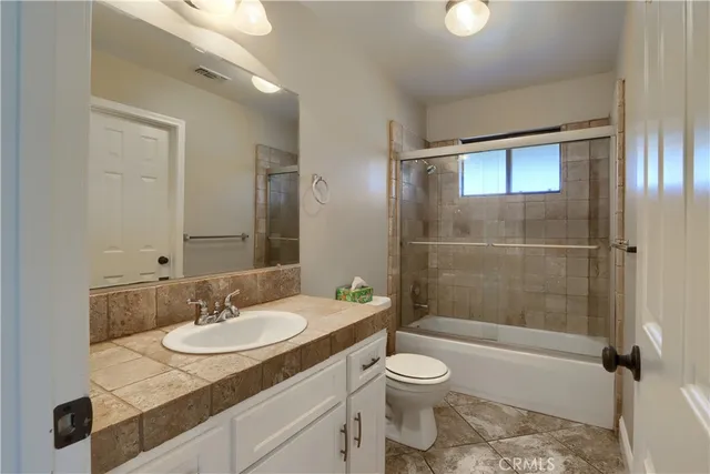 a bathroom with a sink vanity and a mirror