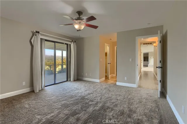 a view of an empty room with a ceiling fan