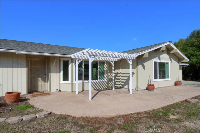 a view of a house with backyard and porch