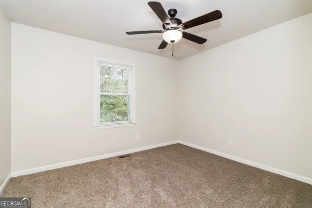 an empty room with a fan