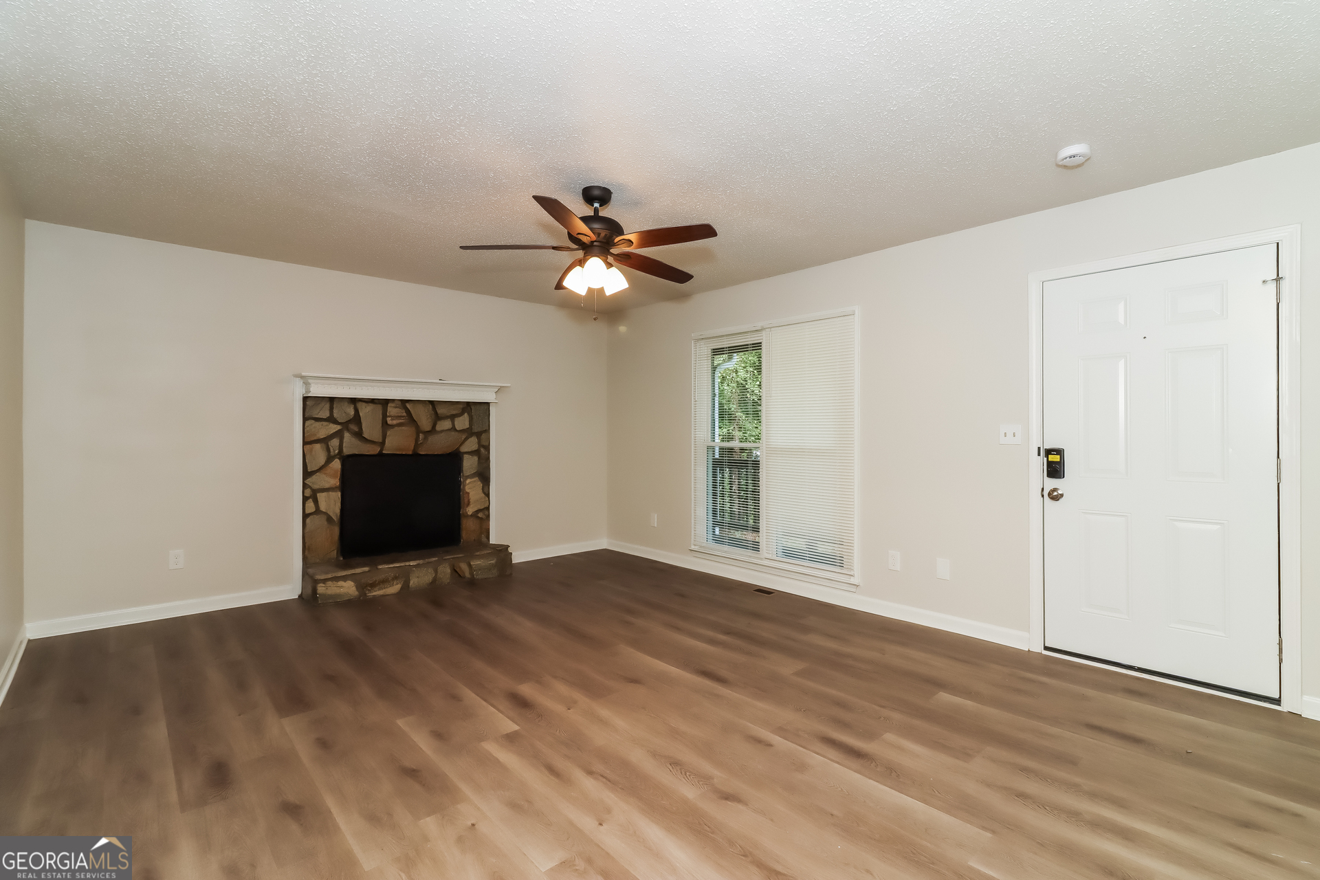 41 Valley Drive Hiram, GA 30141 - Photo 15 of 18 wooden floor in an empty room with a fireplace