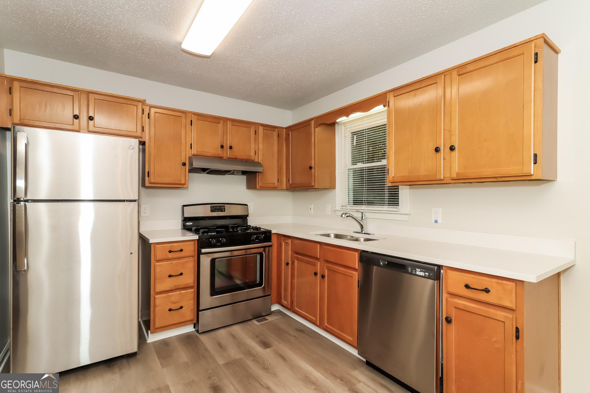 41 Valley Drive Hiram, GA 30141 - Photo 5 of 18 a kitchen with stainless steel appliances granite countertop a refrigerator stove a sink and dishwasher
