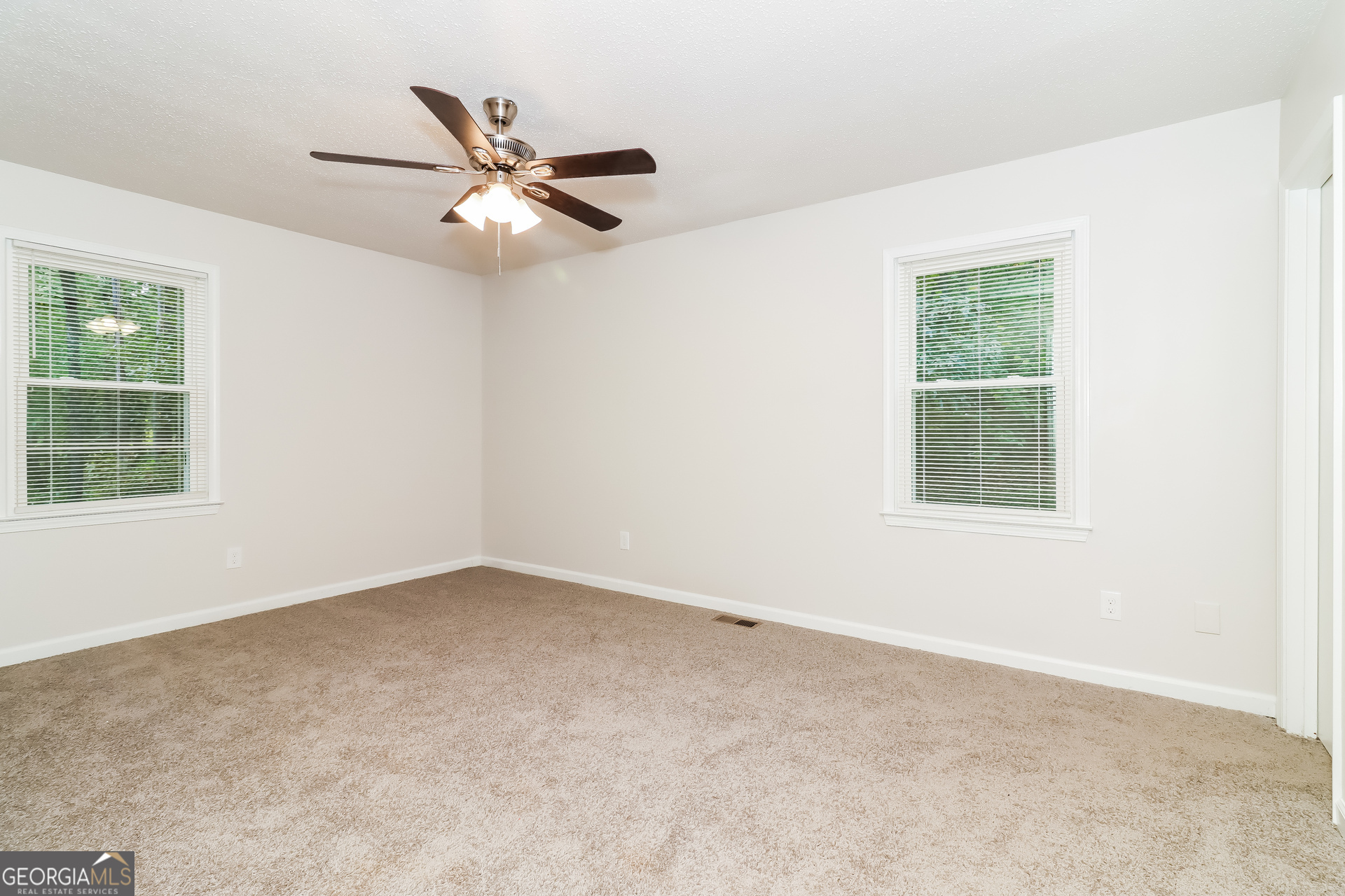 41 Valley Drive Hiram, GA 30141 - Photo 6 of 18 an empty room with a window and a fan