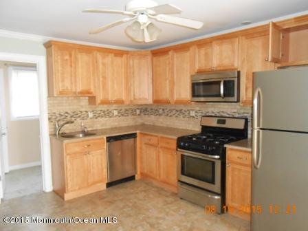 94 Club House Road Brick, NJ 08723 - Photo 3 of 4 a kitchen with stainless steel appliances granite countertop a stove a sink and a microwave