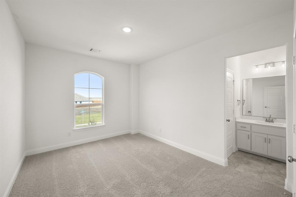 764 Texas Thistle Road Waxahachie, TX 75165 - Photo 16 of 30 an empty room with windows and cabinet