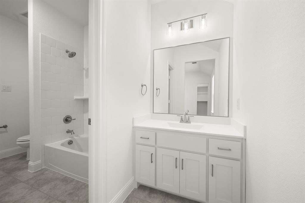 764 Texas Thistle Road Waxahachie, TX 75165 - Photo 19 of 30 a bathroom with a bathtub shower sink vanity and toilet