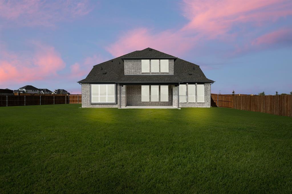 764 Texas Thistle Road Waxahachie, TX 75165 - Photo 25 of 30 a front view of a house with a garden