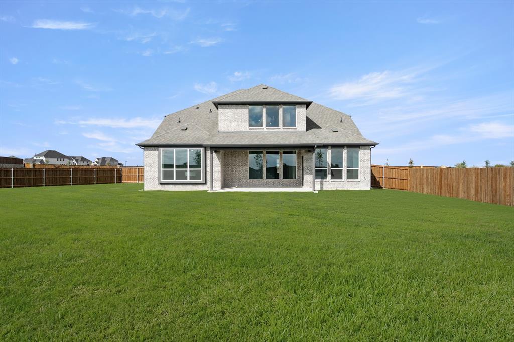 764 Texas Thistle Road Waxahachie, TX 75165 - Photo 26 of 30 a front view of a house with a garden