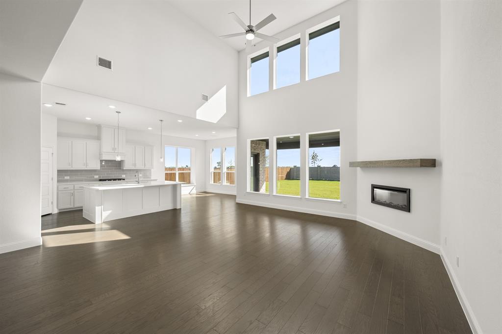 764 Texas Thistle Road Waxahachie, TX 75165 - Photo 6 of 30 a view of a kitchen with furniture and wooden floor
