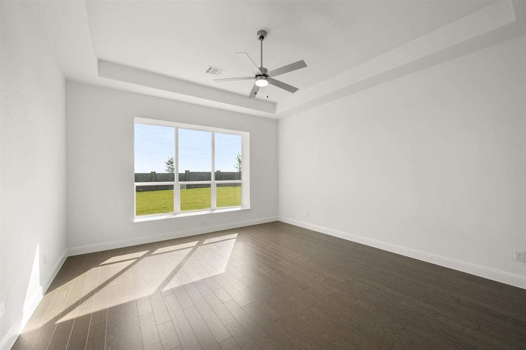 764 Texas Thistle Road Waxahachie, TX 75165 - Photo 9 of 30 an empty room with a window and a ceiling fan
