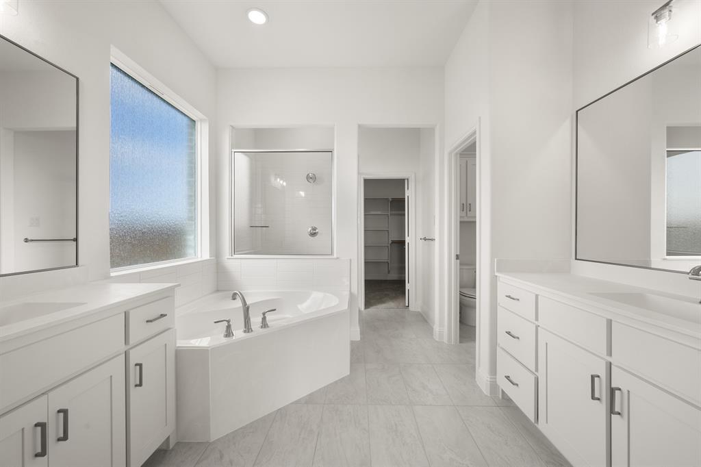 764 Texas Thistle Road Waxahachie, TX 75165 - Photo 10 of 30 a bathroom with a tub sink and mirror