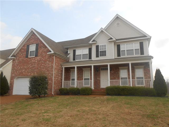3047 Romain Trail Spring Hill, TN 37174 - Photo 1 of 19 a front view of a house with a garden