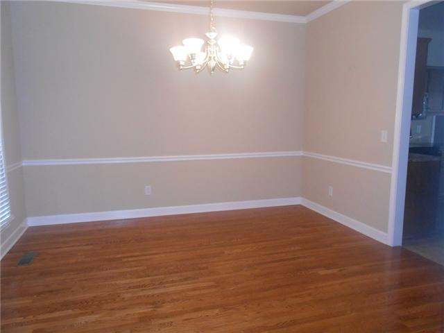 3047 Romain Trail Spring Hill, TN 37174 - Photo 4 of 19 a view of an empty room with wooden floor and a window