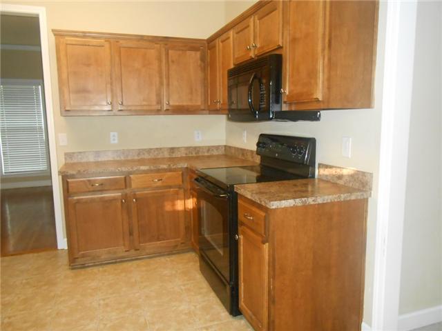 3047 Romain Trail Spring Hill, TN 37174 - Photo 7 of 19 a kitchen with stainless steel appliances granite countertop a stove a microwave and a refrigerator