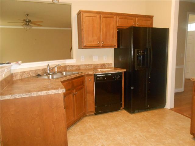 3047 Romain Trail Spring Hill, TN 37174 - Photo 8 of 19 a kitchen with stainless steel appliances granite countertop a refrigerator and a sink
