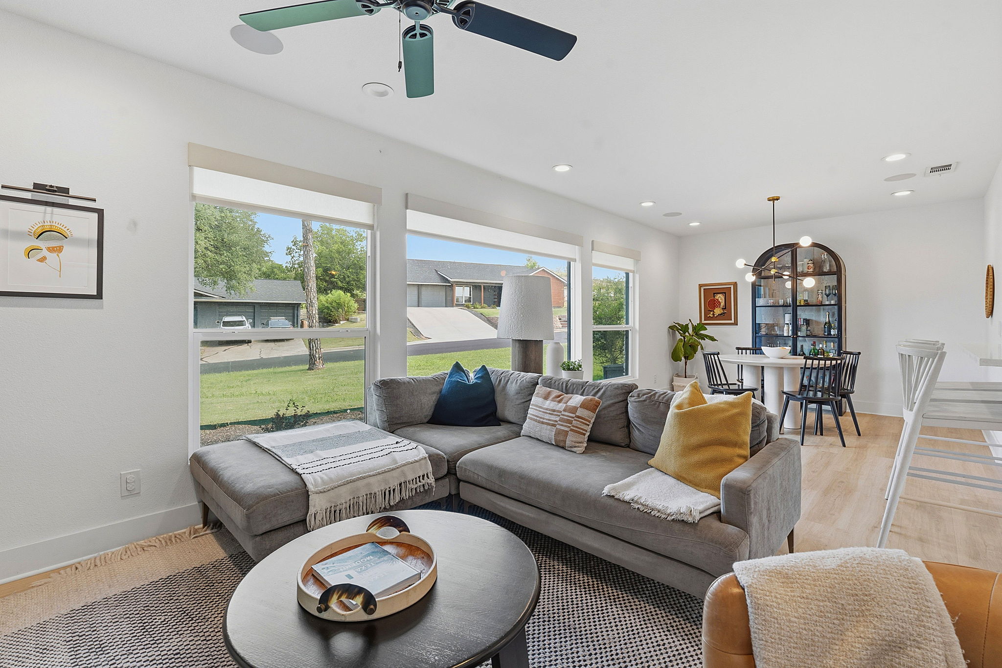 4403 Elmsgrove Drive Austin, TX 78721 - Photo 5 of 38 Floor-to-ceiling windows illuminate this expansive living area, seamlessly connecting to a cozy dining nook.