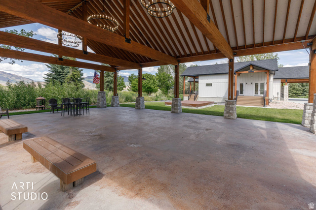 1188 South Old Trappers Loop Road Huntsville, UT 84317 - Photo 8 of 92 Expansive covered outdoor structure featuring exposed wood beams, a vaulted ceiling, and decorative iron chandeliers