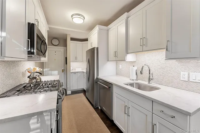 a kitchen with a sink stove and refrigerator