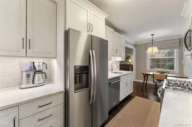 a kitchen with stainless steel appliances a refrigerator sink and cabinets