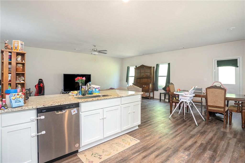 635 Meadows Farm Way Monroe, GA 30655 - Photo 15 of 36 a view of a dining room with furniture and wooden floor