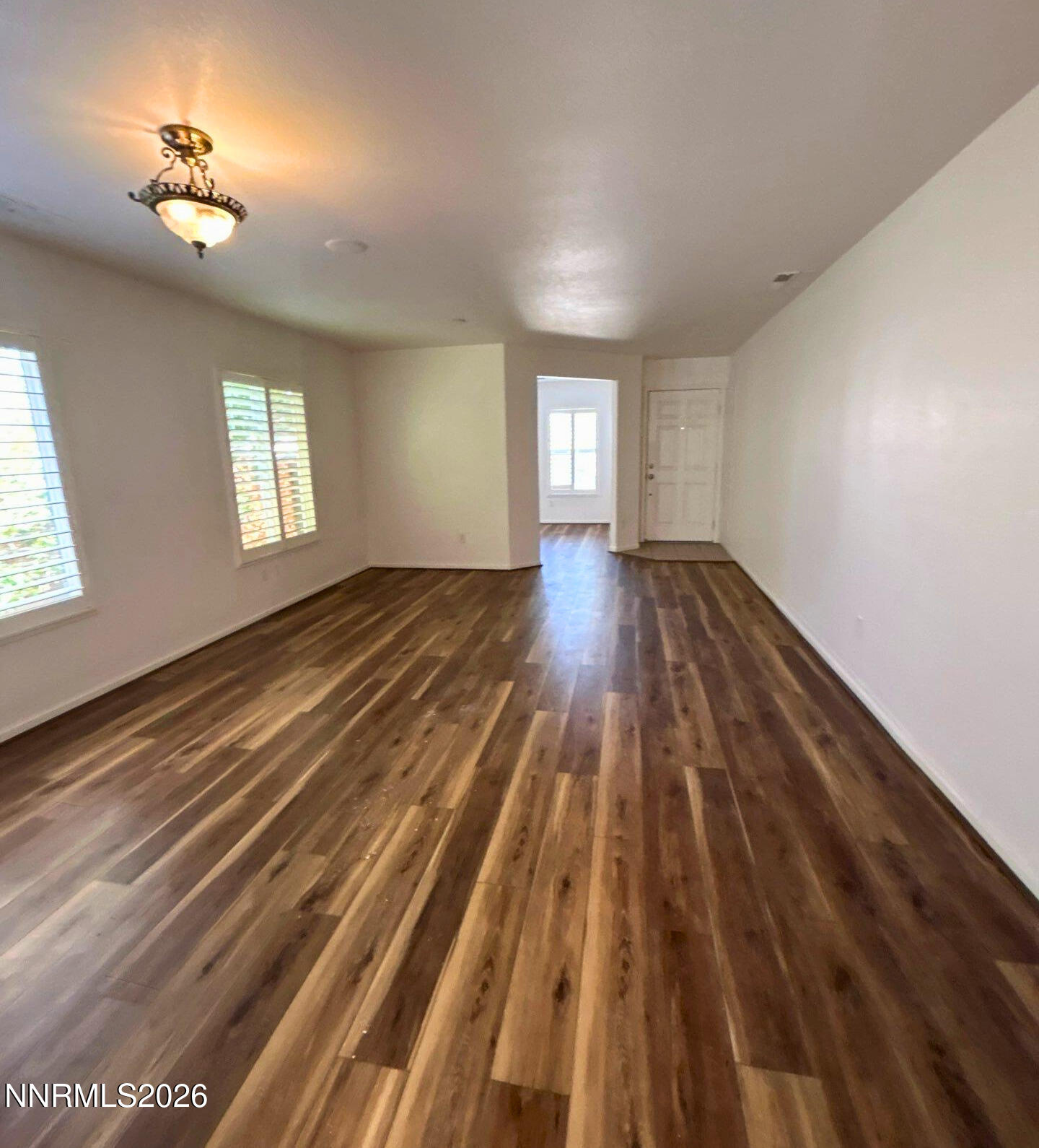 7614 Corso Street Reno, NV 89506 - Photo 2 of 15 wooden floor in an empty room with a window