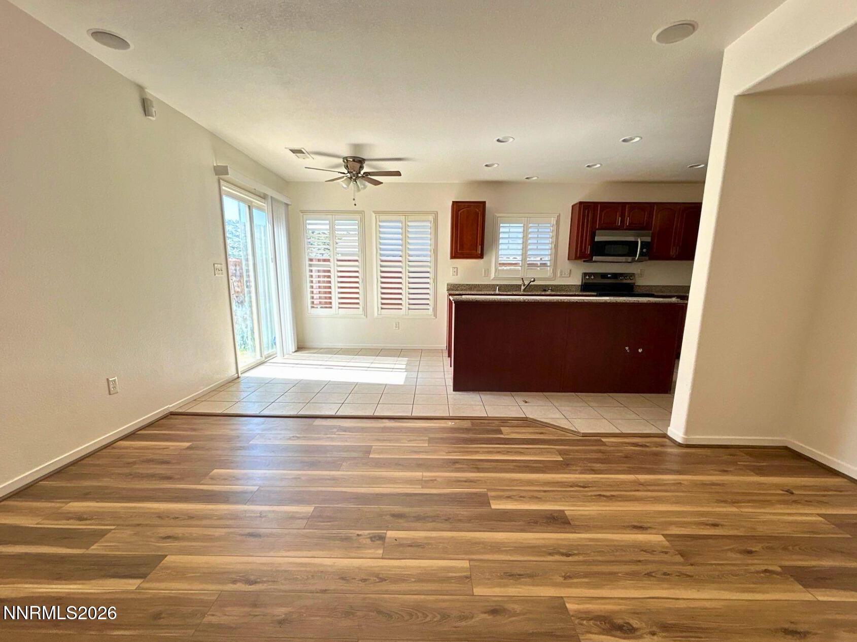 7614 Corso Street Reno, NV 89506 - Photo 5 of 15 a view of a kitchen with kitchen island and wooden floor