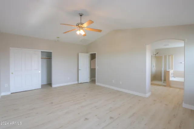 a view of an empty room with a fan