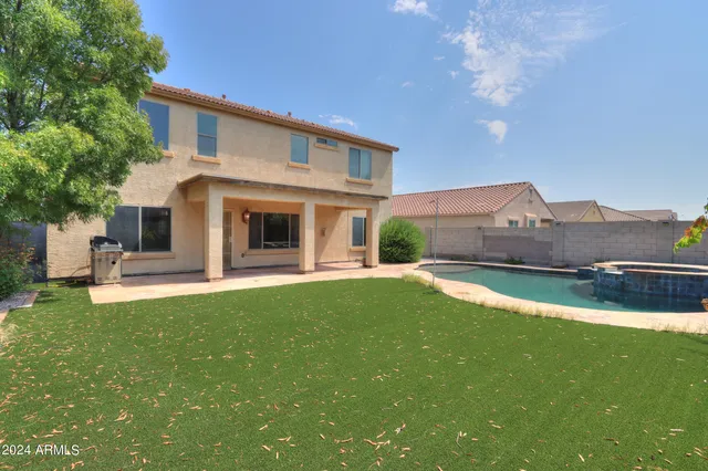 a view of house with garden and a yard