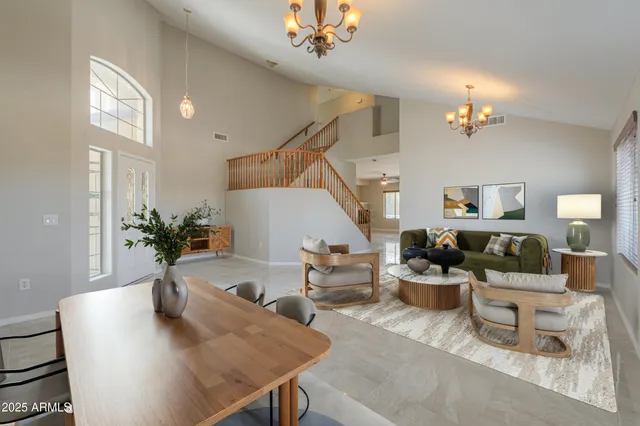 a living room with furniture and a chandelier