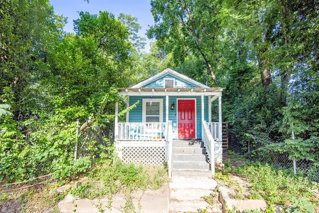 a front view of a house with a garden