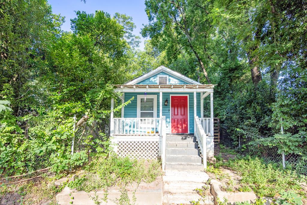 a front view of a house with a garden