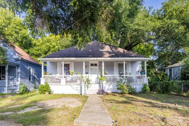 a front view of a house with a garden