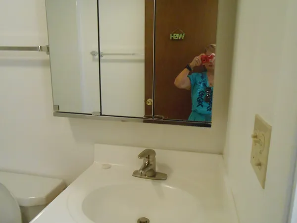 a bath room with a toilet and a bath tub