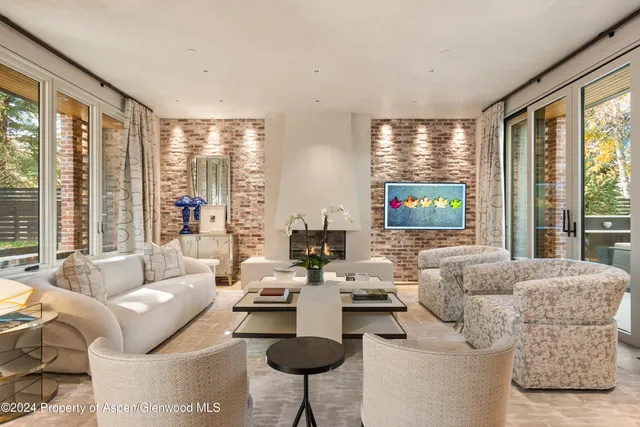a living room with a fireplace and a chandelier