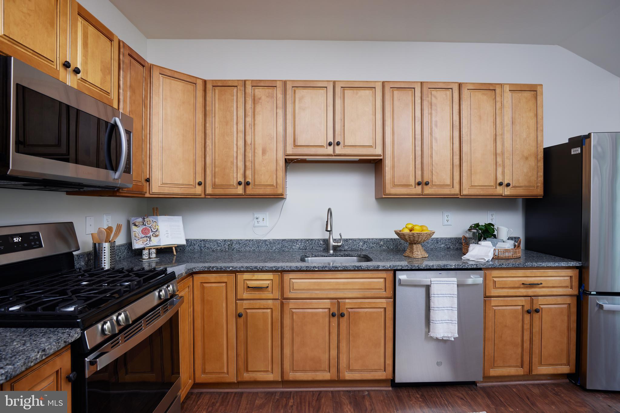 2723 Deer Ridge Drive Silver Spring, MD 20904 - Photo 15 of 45 a kitchen with stainless steel appliances granite countertop a stove a sink dishwasher and cabinets with wooden floor