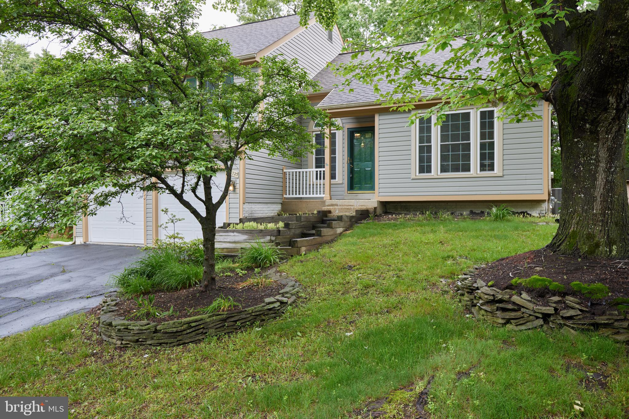 2723 Deer Ridge Drive Silver Spring, MD 20904 - Photo 3 of 45 a view of a backyard with plants and large trees