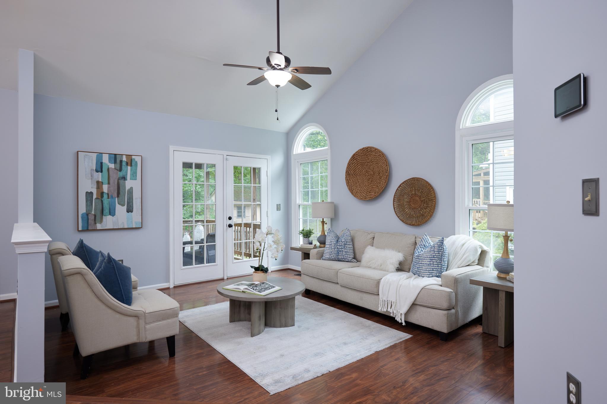 2723 Deer Ridge Drive Silver Spring, MD 20904 - Photo 34 of 45 a living room with couches a dining table and chair with wooden floor