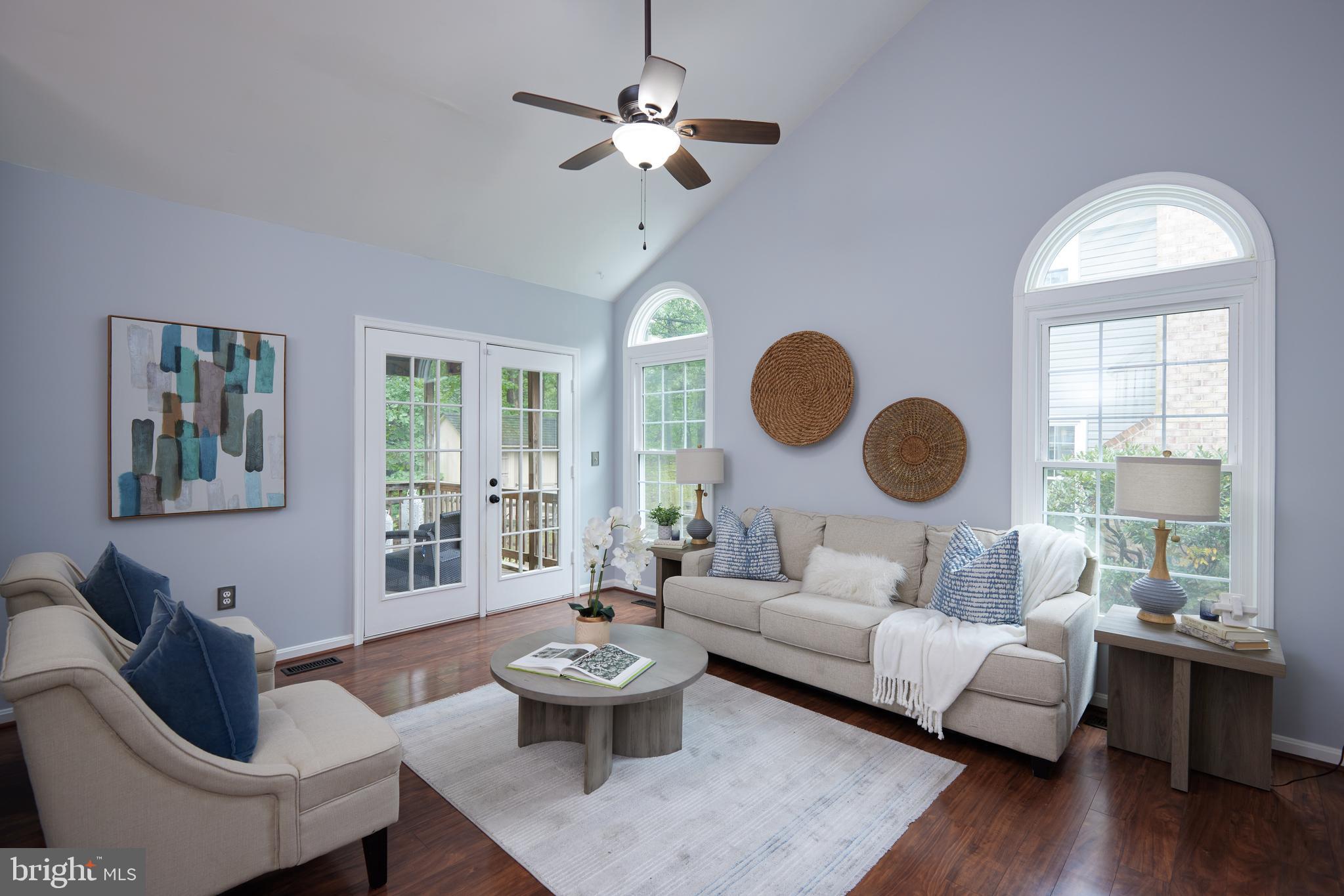 2723 Deer Ridge Drive Silver Spring, MD 20904 - Photo 35 of 45 a living room with couches a chandelier and a large mirror with wooden floor