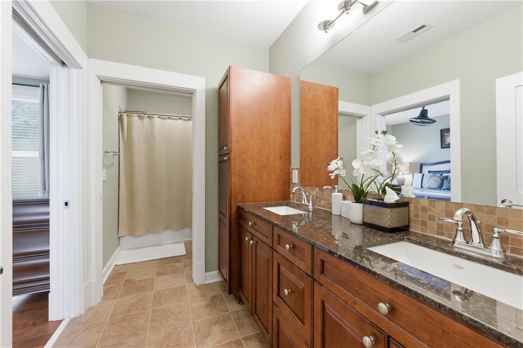 117 South Bay Road, Unit 402 Eatonton, GA 31024 - Photo 14 of 48 a bathroom with a granite countertop sink and a mirror