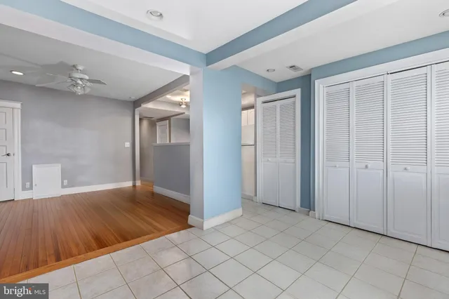 a kitchen with granite countertop white cabinets and refrigerator