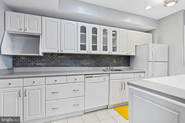 a view of an empty room with window and chandelier fan
