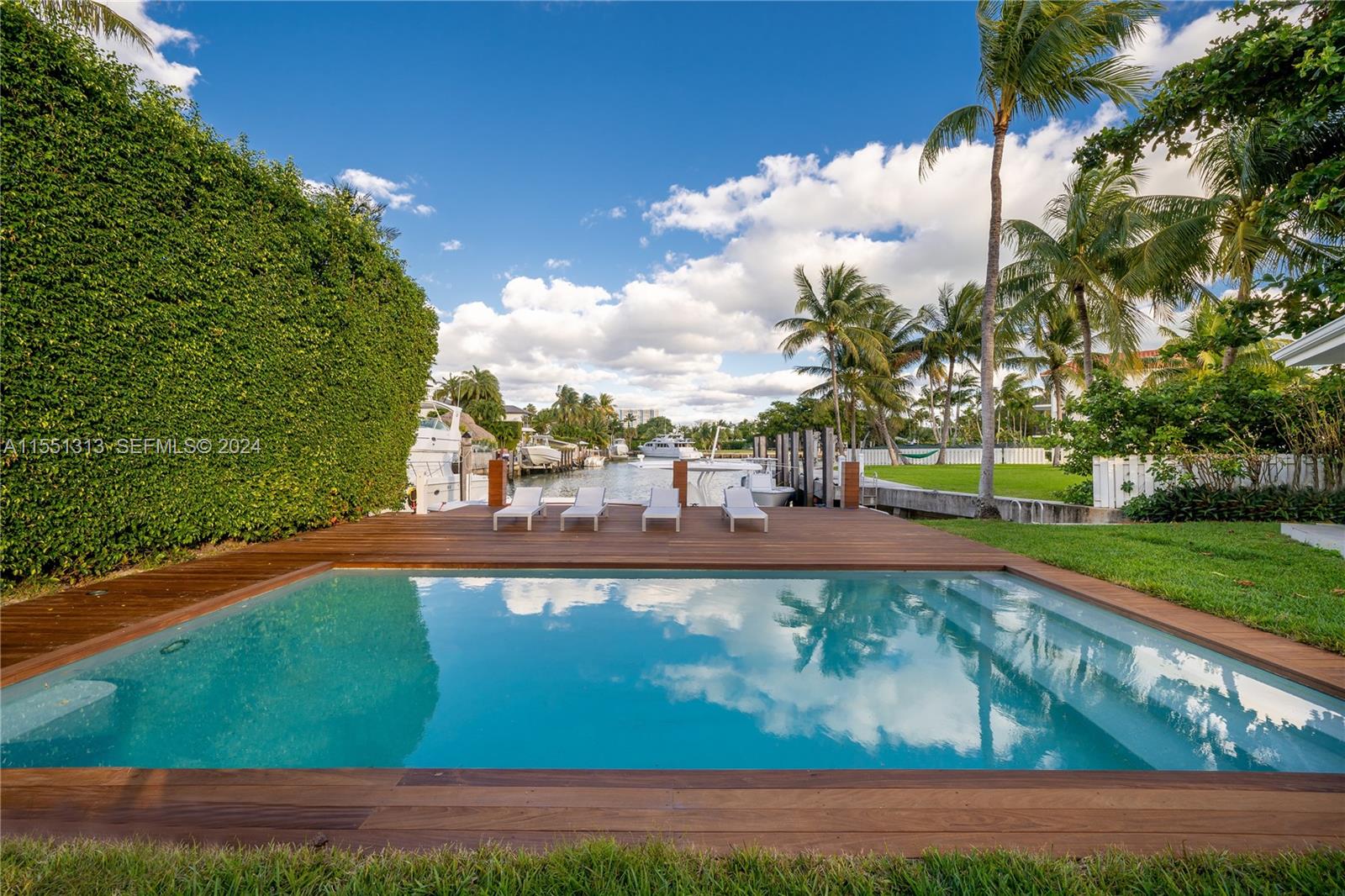 861 Harbor Drive Key Biscayne, FL 33149 - Photo 1 of 33 a view of swimming pool with seating space and trees in the background