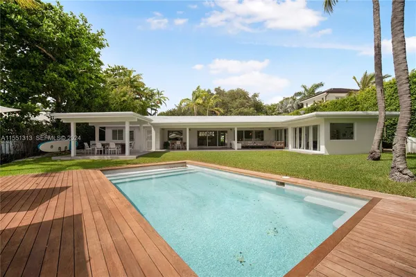 a view of house with swimming pool and porch