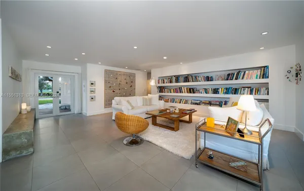 a living room with furniture and a book shelf
