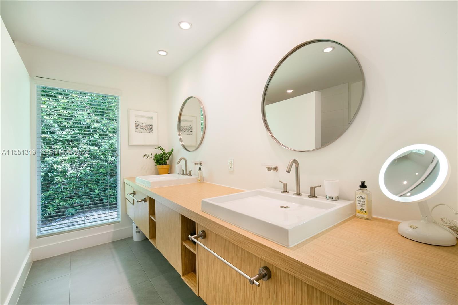 861 Harbor Drive Key Biscayne, FL 33149 - Photo 27 of 33 a bathroom with a double vanity sink and a mirror