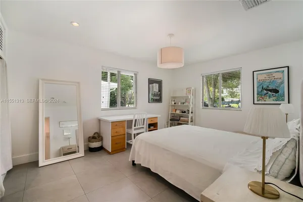 a bedroom with a bed and a table